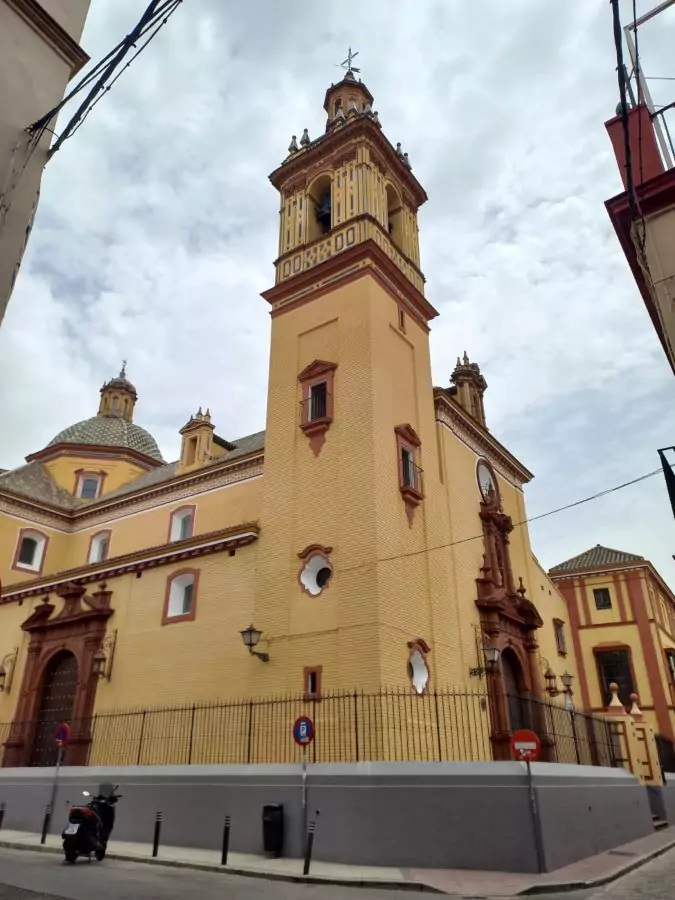 Edificio alto y grnade con campanario rojo y amarillo